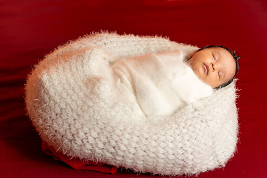 a baby wrapped in a blanket