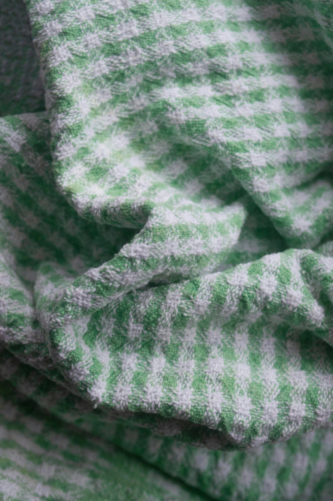 a close up of a green and white blanket
